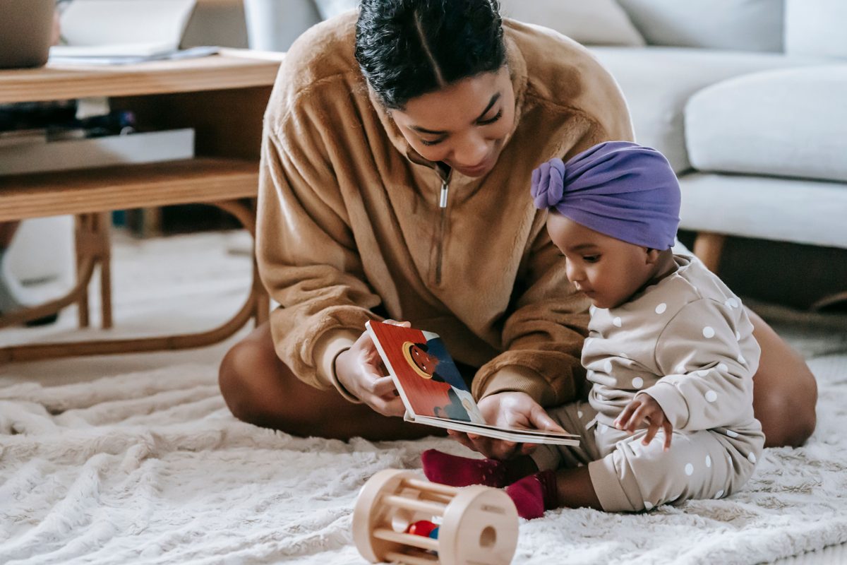 Mother sharing a picture book with her baby